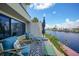 Cozy outdoor patio with comfortable seating and a picturesque view of the waterfront at 25188 Marion Ave # 1033, Punta Gorda, FL 33950