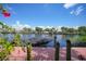 Tranquil waterfront view showcasing a private dock, lush greenery, and calm waters at 25188 Marion Ave # 1033, Punta Gorda, FL 33950