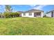 A verdant backyard provides a private outdoor living space with screened in lanai at 25340 E Lenox Cir, Punta Gorda, FL 33950