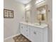 Bathroom featuring double vanity, framed mirrors and modern lighting fixtures at 25340 E Lenox Cir, Punta Gorda, FL 33950