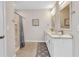 Bathroom featuring double vanity, framed mirrors, and a separate shower at 25340 E Lenox Cir, Punta Gorda, FL 33950