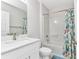Bright bathroom featuring a white single sink vanity, toilet, and tub with stylish shower curtain at 25340 E Lenox Cir, Punta Gorda, FL 33950