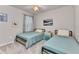 Comfortable bedroom featuring two twin beds, carpet, and ceiling fan at 25340 E Lenox Cir, Punta Gorda, FL 33950