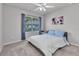 Bedroom featuring comfortable carpet, a ceiling fan, and a view of the outside at 25340 E Lenox Cir, Punta Gorda, FL 33950