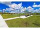 Outdoor bocce ball court with covered seating area and lush green landscaping perfect for an active community lifestyle at 25340 E Lenox Cir, Punta Gorda, FL 33950