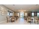 Bright dining area with multiple tables, chairs, and large windows, offering a welcoming space for community gatherings at 25340 E Lenox Cir, Punta Gorda, FL 33950
