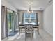 Dining room features chandelier, natural light and sliding glass doors to backyard at 25340 E Lenox Cir, Punta Gorda, FL 33950