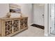 Welcoming foyer with neutral tones, tile flooring, cabinet, and stylish decor, leading to other rooms at 25340 E Lenox Cir, Punta Gorda, FL 33950