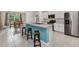 Open kitchen features stainless steel appliances, large island with seating, and tile flooring at 25340 E Lenox Cir, Punta Gorda, FL 33950