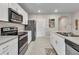 Kitchen features stainless steel appliances, white cabinets, and hard surface countertops at 25340 E Lenox Cir, Punta Gorda, FL 33950