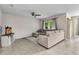 Comfortable living room with tile floors, neutral walls, ceiling fan, and plenty of natural light at 25340 E Lenox Cir, Punta Gorda, FL 33950