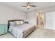 Bright main bedroom with tile floors, a ceiling fan, and en-suite access at 25340 E Lenox Cir, Punta Gorda, FL 33950