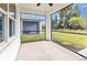 Screened in patio shows backyard views, ceiling fan, and an additional screened in building at 25340 E Lenox Cir, Punta Gorda, FL 33950