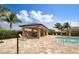 Beautiful pool featuring a covered lounge area, lush landscaping, and ample seating for residents at 25340 E Lenox Cir, Punta Gorda, FL 33950