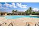 Gorgeous community pool with ample seating and covered lounging areas, surrounded by tropical landscaping at 25340 E Lenox Cir, Punta Gorda, FL 33950