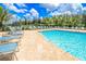 Well-maintained community pool with ample seating and landscaping, creating a relaxing outdoor space at 25340 E Lenox Cir, Punta Gorda, FL 33950