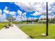 Community recreation area featuring bocce ball and tennis, with benches and shaded seating areas at 25340 E Lenox Cir, Punta Gorda, FL 33950
