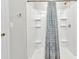Bright shower featuring built in shelves and a modern shower curtain at 25340 E Lenox Cir, Punta Gorda, FL 33950