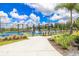 Outdoor tennis and pickleball courts enclosed by black fencing and surrounded by manicured greenery at 25340 E Lenox Cir, Punta Gorda, FL 33950