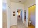 Hallway view features multiple doorways to bedrooms and bathrooms with neutral tile floors at 2607 Valerian Way, North Port, FL 34289
