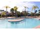 Stunning community pool featuring a sun deck and tropical landscaping, perfect for relaxation and recreation at 2607 Valerian Way, North Port, FL 34289