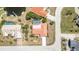 Aerial shot of a single-Gathering home with a pool, surrounded by palm trees and other residences at 2621 Via Veneto Dr, Punta Gorda, FL 33950
