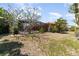 Lush backyard with mature trees and a screened-in pool area, offering a private outdoor space at 2621 Via Veneto Dr, Punta Gorda, FL 33950
