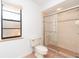 Bathroom with window and glass enclosed shower featuring tile surround at 2621 Via Veneto Dr, Punta Gorda, FL 33950