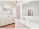 Bright bathroom featuring tiled floors, a large vanity, and dual mirrors at 2621 Via Veneto Dr, Punta Gorda, FL 33950