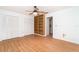 Spacious bedroom with laminate floors, double closets, and built-in bookshelf at 2621 Via Veneto Dr, Punta Gorda, FL 33950