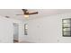 Bright bedroom with hardwood floors, two windows, and ceiling fan at 2621 Via Veneto Dr, Punta Gorda, FL 33950