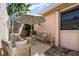 Cozy courtyard area featuring comfortable seating, a shade umbrella, and a peaceful ambiance at 2621 Via Veneto Dr, Punta Gorda, FL 33950