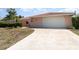 Front exterior view of a home with a spacious driveway and well maintained exterior features at 2621 Via Veneto Dr, Punta Gorda, FL 33950