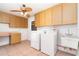 Functional laundry room with ample cabinet storage, countertop space, and utility sink at 2621 Via Veneto Dr, Punta Gorda, FL 33950