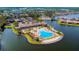 Aerial view of waterfront clubhouse, pool, and community amenities surrounded by lush landscaping at 264 Soliera St, Nokomis, FL 34275