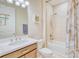 Well-lit bathroom with tub-shower combination, marble shower curtain, white cabinets and vanity with sink at 264 Soliera St, Nokomis, FL 34275