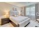 Comfortable bedroom featuring a stylish bed with an upholstered headboard, complementary furniture, and natural light at 264 Soliera St, Nokomis, FL 34275