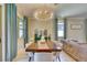 Well-lit dining room with a large table, comfortable seating, and stylish decor creates an inviting space at 264 Soliera St, Nokomis, FL 34275