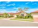 Charming one-story home with tile roof, mature landscaping, palm trees, and brick-paved driveway at 264 Soliera St, Nokomis, FL 34275