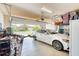 A tidy two-car garage featuring a white vehicle, a variety of stored items, and an automatic door opener at 264 Soliera St, Nokomis, FL 34275