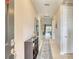 Inviting hallway with decorative accents, a stylish runner, and access to the front door for a warm welcome at 264 Soliera St, Nokomis, FL 34275