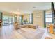 Spacious living room with comfortable seating, stylish decor, and large windows offering plenty of natural light at 264 Soliera St, Nokomis, FL 34275