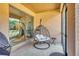 Cozy screened-in patio featuring a black hanging swing chair and view of the house at 264 Soliera St, Nokomis, FL 34275