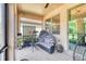 Cozy screened-in patio featuring a shaded daybed, ceiling fan, and other sitting arrangements at 264 Soliera St, Nokomis, FL 34275