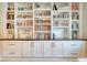 Custom shelving with a variety of books and decor creates a functional and stylish focal point at 264 Soliera St, Nokomis, FL 34275