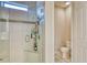 Tiled shower room featuring a glass door, built-in seat, and open access to an adjacent half-bath for added convenience at 264 Soliera St, Nokomis, FL 34275