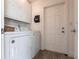 Bright laundry room featuring a white washer, dryer, and storage cabinets, perfect for efficient home management at 275 Tait Se Ter, Port Charlotte, FL 33952
