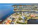 Stunning aerial view of waterfront homes with private pools and boat docks in a coastal community at 310 Severin Se Rd, Port Charlotte, FL 33952