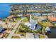 Aerial view of home featuring pool, spa, covered lanai, lush landscaping and canal with boat lift at 310 Severin Se Rd, Port Charlotte, FL 33952