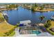 Waterfront home showcasing screened-in pool area, boat lift, and canal access at 310 Severin Se Rd, Port Charlotte, FL 33952